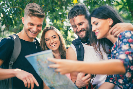 Young people tourists searching for direction using paper mapの写真素材