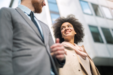 Businesspeople commuting and walking in busy city togetherの写真素材