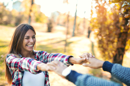 Couple in love in autumn.Smiling young couple hugging in the park.の写真素材