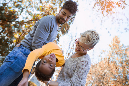 Happy young mixed race couple spending time with their daughterの写真素材