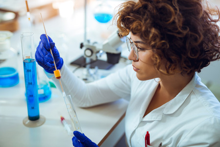 Woman collects forensic DNA sample stick in laboratory