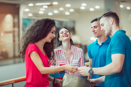 Group Of Young Friends Shopping In Mall Togetherの写真素材