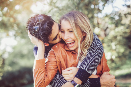 Happy couple in love having fun outdoors and smiling.の写真素材