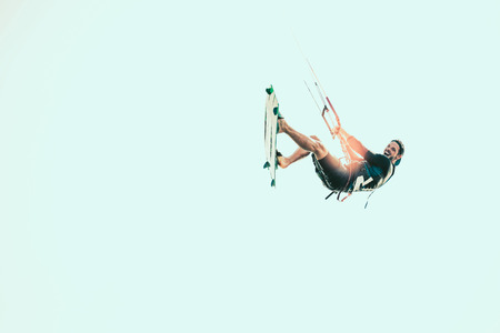 Kitesurfing Kiteboarding action photos man among waves quickly goes