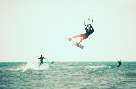Kitesurfing Kiteboarding action photos man among waves quickly goesの写真素材