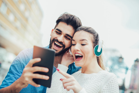 Young attractive couple looking at digital tablet.の写真素材