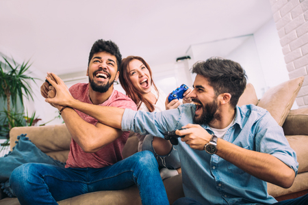 Group of friends play video games together.の写真素材