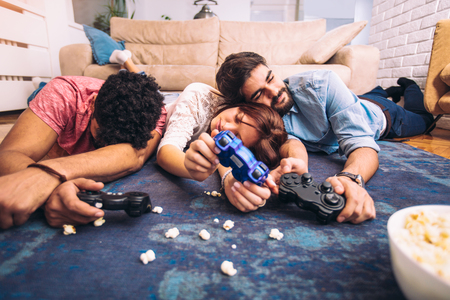 Group of friends play video games together.の写真素材