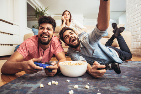 Group of friends play video games together.の写真素材