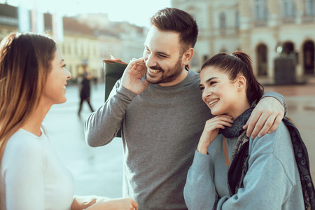 Happy friends shopping. Young friends enjoying shopping in the city.の写真素材