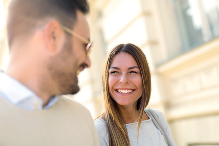 Beautiful young couple smiling while walking outdoors on sunny day
の写真素材