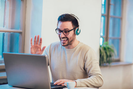Man in front of laptop computer with headsetの写真素材