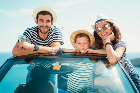 Happy family travel by car to the sea. People having fun in cabriolet. Summer vacation conceptの写真素材