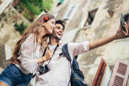 Romantic tourist couple using digital tablet computerの写真素材