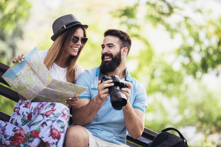 Happy tourist couple  in the park on a sunny dayの写真素材