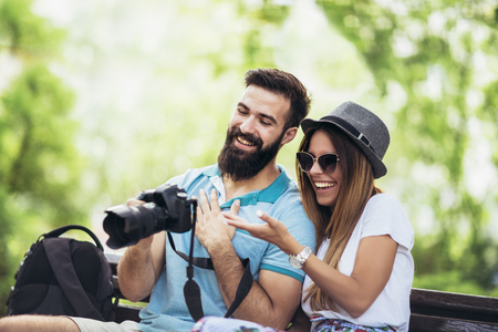 Happy tourist couple  in the park on a sunny dayの写真素材