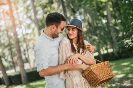 Cheerful young couple having fun and laughing together outdoorsの写真素材