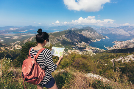 Tourist hold and look map on trip, lifestyle concept adventure, traveler with backpack on background...