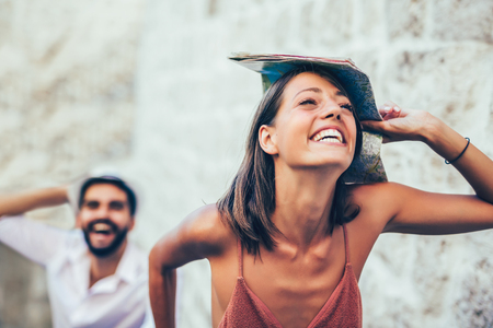Traveling couple of tourists walking around old town. Vacation, summer, holiday, tourism: concept.の写真素材