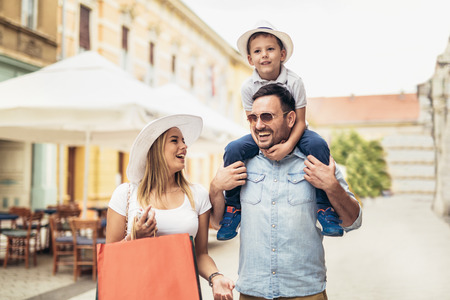 Happy family having fun outdoor after shoppingの写真素材