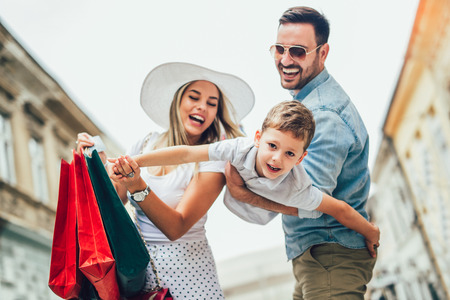 Happy family having fun outdoor after shoppingの写真素材