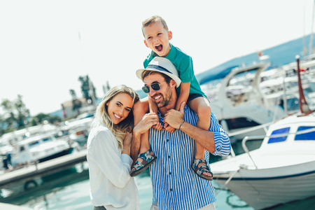 Happy family having fun, enjoying the summer time by the sea.