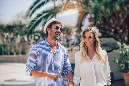 Beautiful couple taking a walk in city parkの写真素材