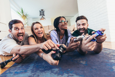 Group of friends play video games together.