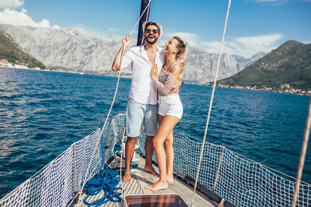 Couple in love on a sail boat in the summer.