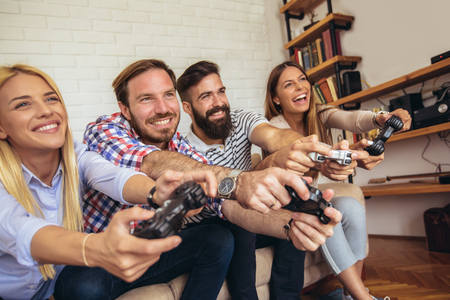 Group of friends play video games together.の写真素材