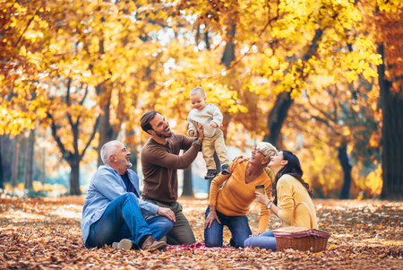 Multl generation family in autumn park having funの写真素材