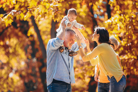 Multl generation family in autumn park having funの写真素材