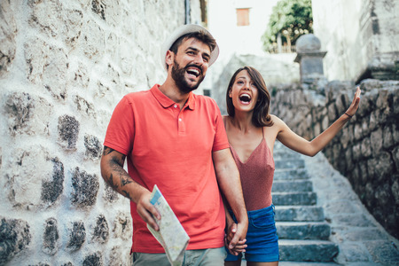 Traveling couple of tourists walking around old town. Vacation, summer, holiday, tourism: concept.の写真素材