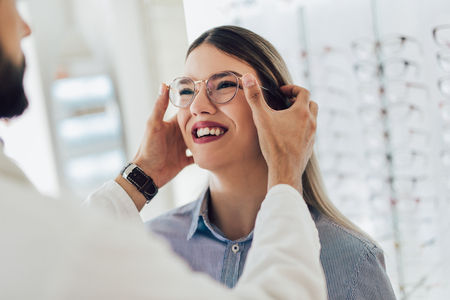 Ophthalmologist doing a visual examination for a customer at an optical center.の写真素材