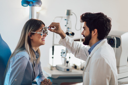 Optometrist checking patient eyesight and vision correction