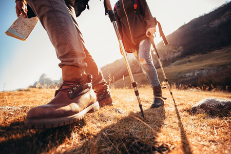 Hiking man and woman with trekking boots on the trailの写真素材