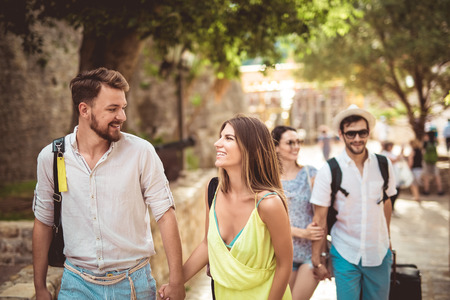 Young happy tourists sightseeing in cityの写真素材