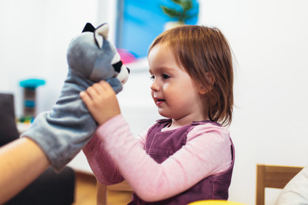 Cute child playing on table indoor, selective focus.の写真素材