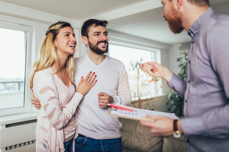 Real Estate agent shows interior to young coupleの写真素材