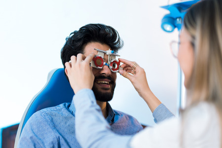 Optometrist checking patient eyesight and vision correctionの写真素材