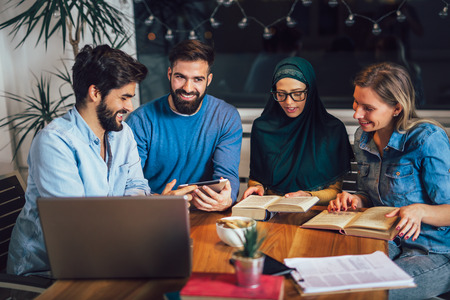 Group of students of diverse ethnic learning at home. Learning and preparing for university exam, selective focus.の写真素材