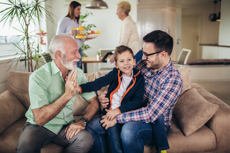 Portrait of a three generation family spending time together at home.の写真素材