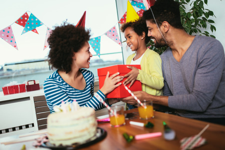 Happy family celebrating a birthday together at home