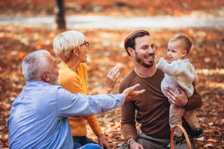 Multl generation family in autumn park having funの写真素材