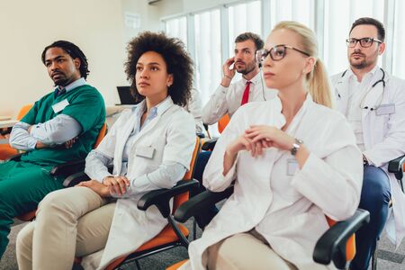 Group of happy doctors on seminar in lecture hall at hospitalの写真素材