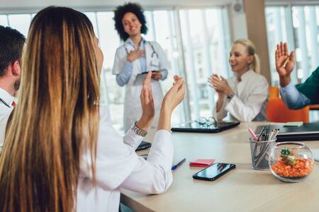 Medical team sitting and discussing at the table in the office.の写真素材