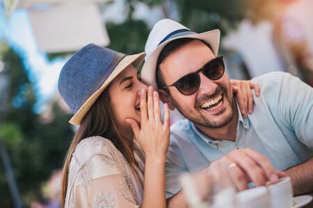 Beautiful loving couple sitting in a cafe enjoying in coffee and conversationの写真素材
