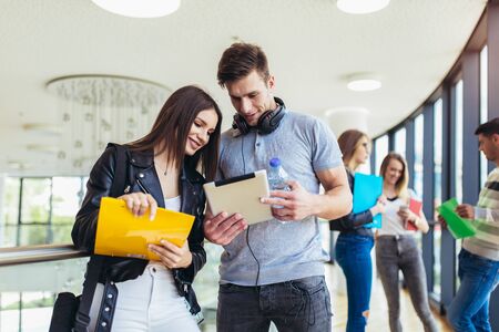 Two students using digital tablet in a universityの写真素材