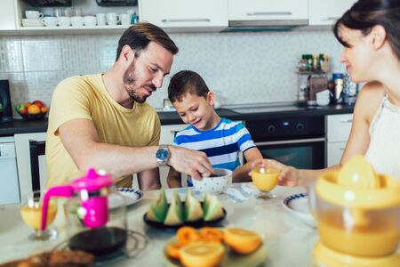 Family Eating Breakfast At Kitchen Tableの写真素材