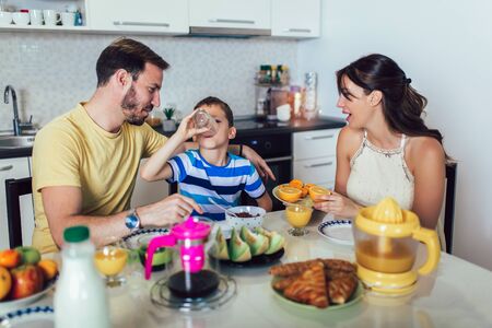 Family Eating Breakfast At Kitchen Tableの写真素材